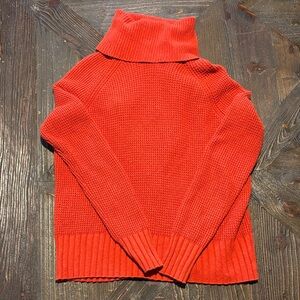 Madewell Eastbrook turtleneck crossback sweater in orange.